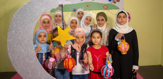 CH1669473 Children work on their lanterns for Ramadan in the child friendly space