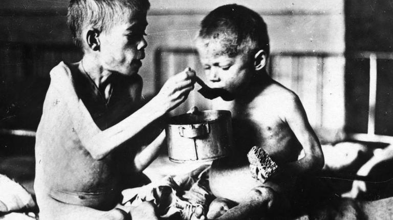 child feeding another child